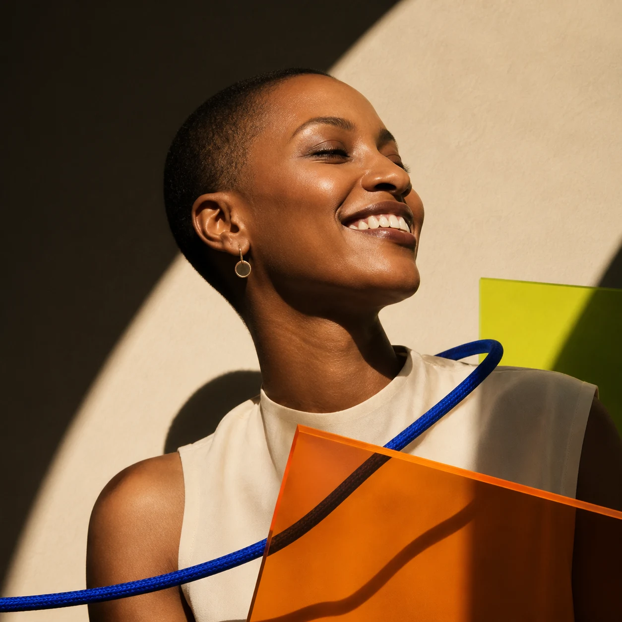 Joyful sculptural portrait with cobalt cord and amber acrylic